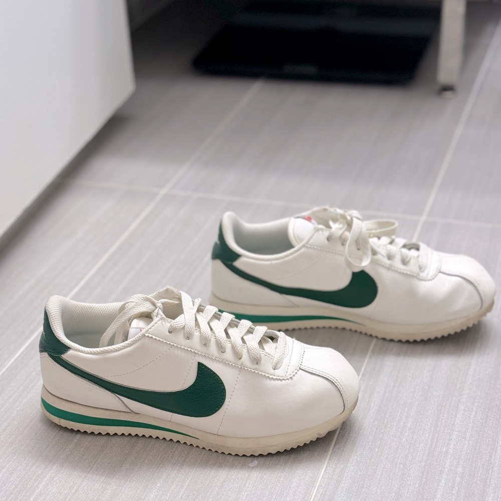 Women’s Nike Cortez size W 7.5. Leather and has a green accent 'Swoosh'.